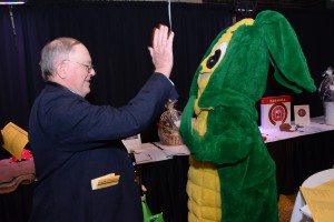 The Minnesota Corn Growers Association mascot congratulates a winning bidder at the auction.