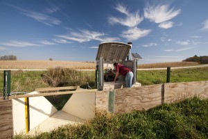 Soil scientist Kevin Kuehner checks the edge-of-field monitoring equipment at a site near Bridge Creek in Southeastern Minnesota.