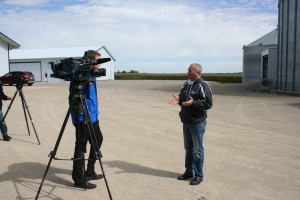 Roger Toquam interviewing with local media during the tour on Sunday.