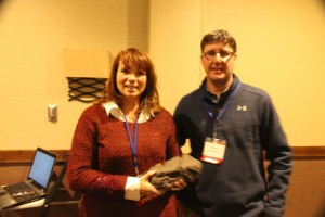 Jodi DeJong-Hughes holding "Clod-dette" with Terry Wehlander at the Conservation Tillage Conference.