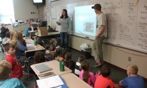 Brian and Anna talking to school children about their Minnesota 4H Science of Agriculture Challenge project.