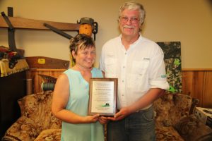 John and Jewell Peterson receive a plaque in recognition of six years participation in Minnesota Discovery Farms.