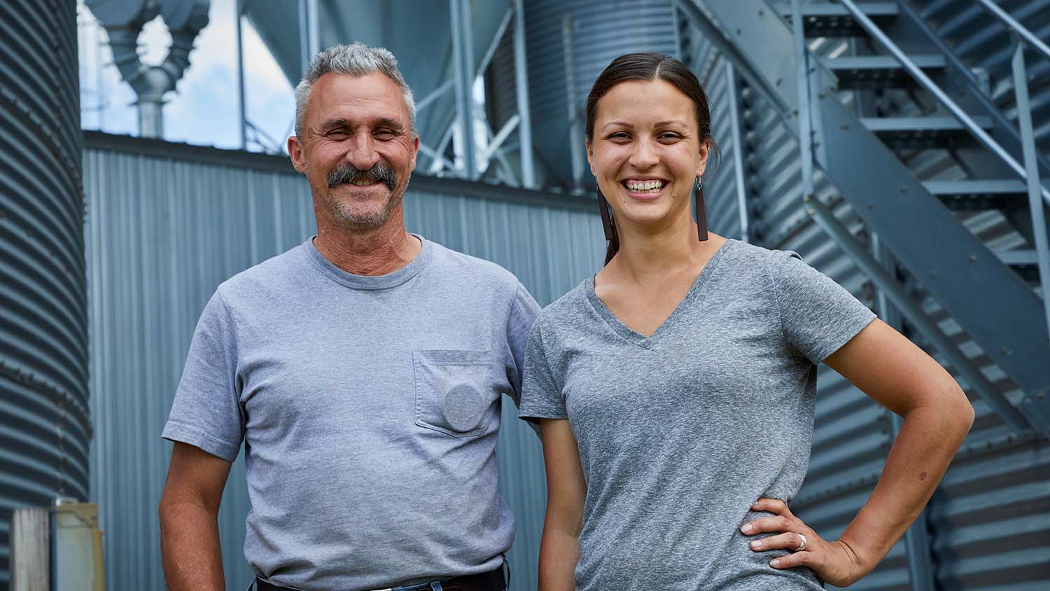 Farmer and his daughter smiling outdoors
